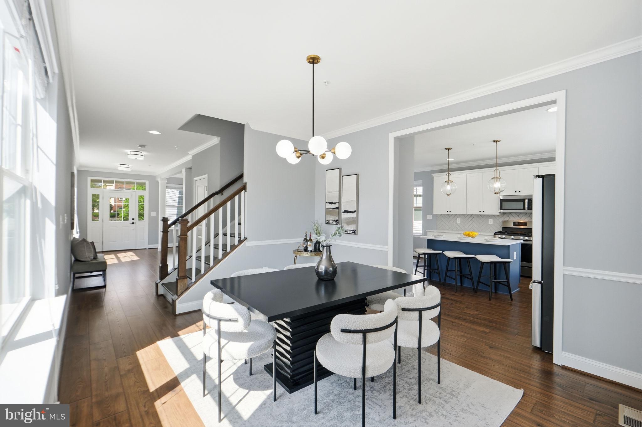 14309 Drayton Avenue Silver Spring, MD 20904 - Photo 14 of 44 a dining room with furniture a chandelier and wooden floor