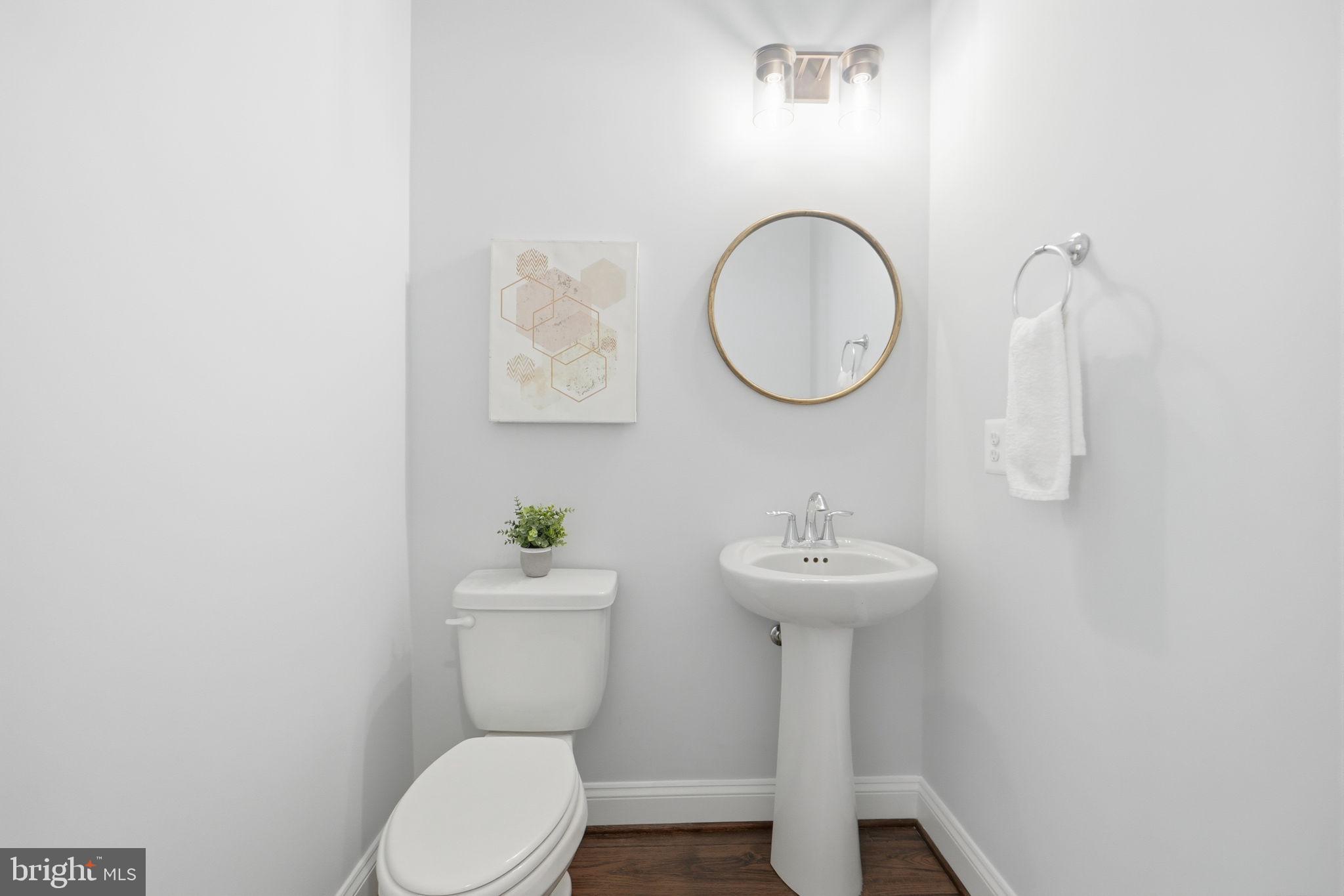 14309 Drayton Avenue Silver Spring, MD 20904 - Photo 15 of 44 a bathroom with a toilet a sink and mirror