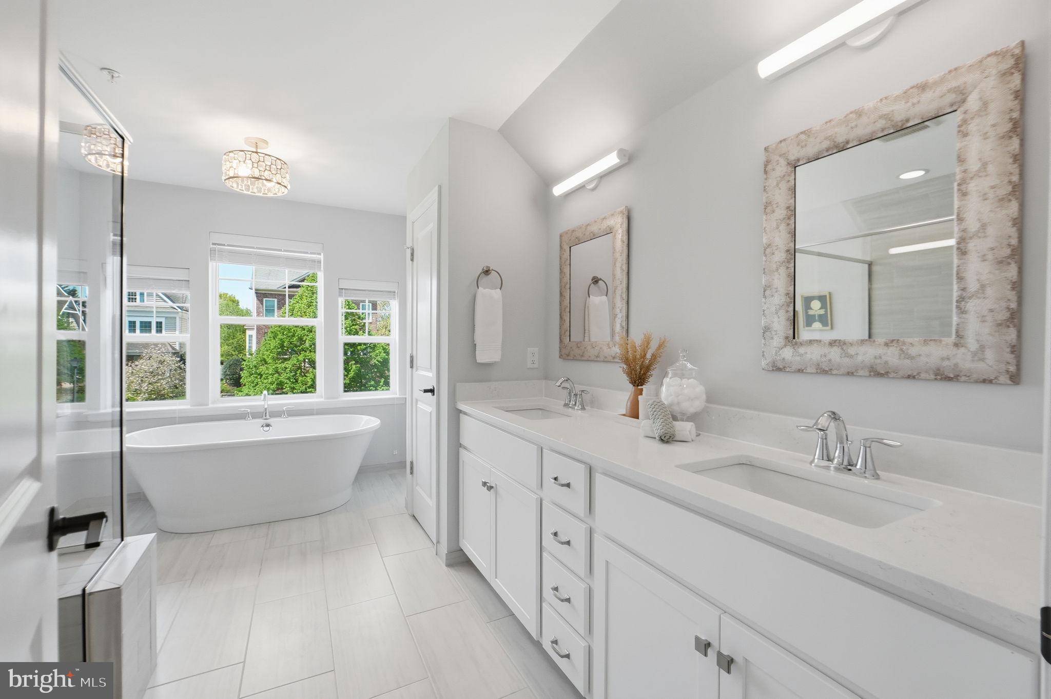 14309 Drayton Avenue Silver Spring, MD 20904 - Photo 19 of 44 a bathroom with a double vanity sink a large mirror a bathtub and next to a window