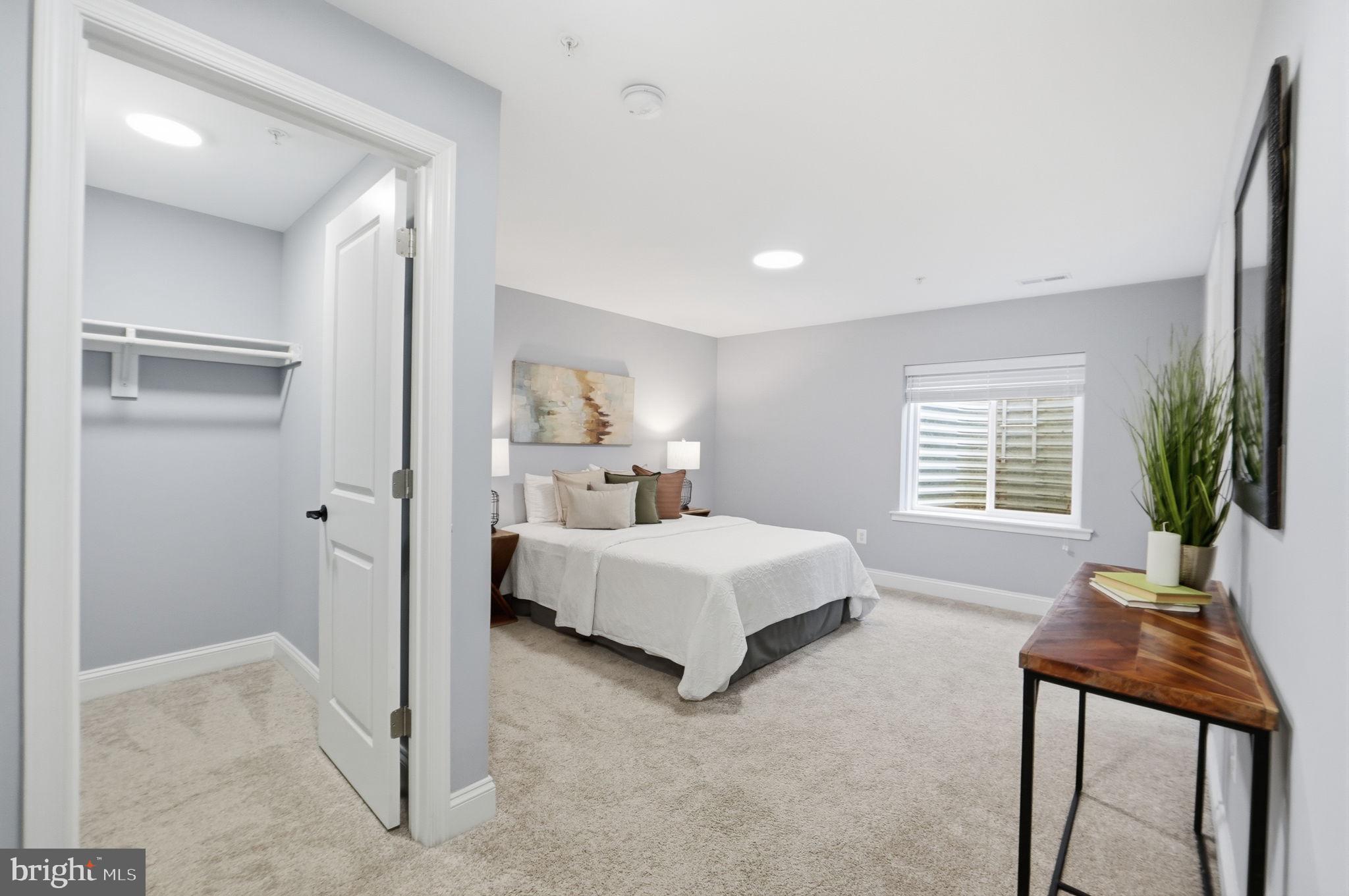 14309 Drayton Avenue Silver Spring, MD 20904 - Photo 34 of 44 a spacious bedroom with a bed and a table in it