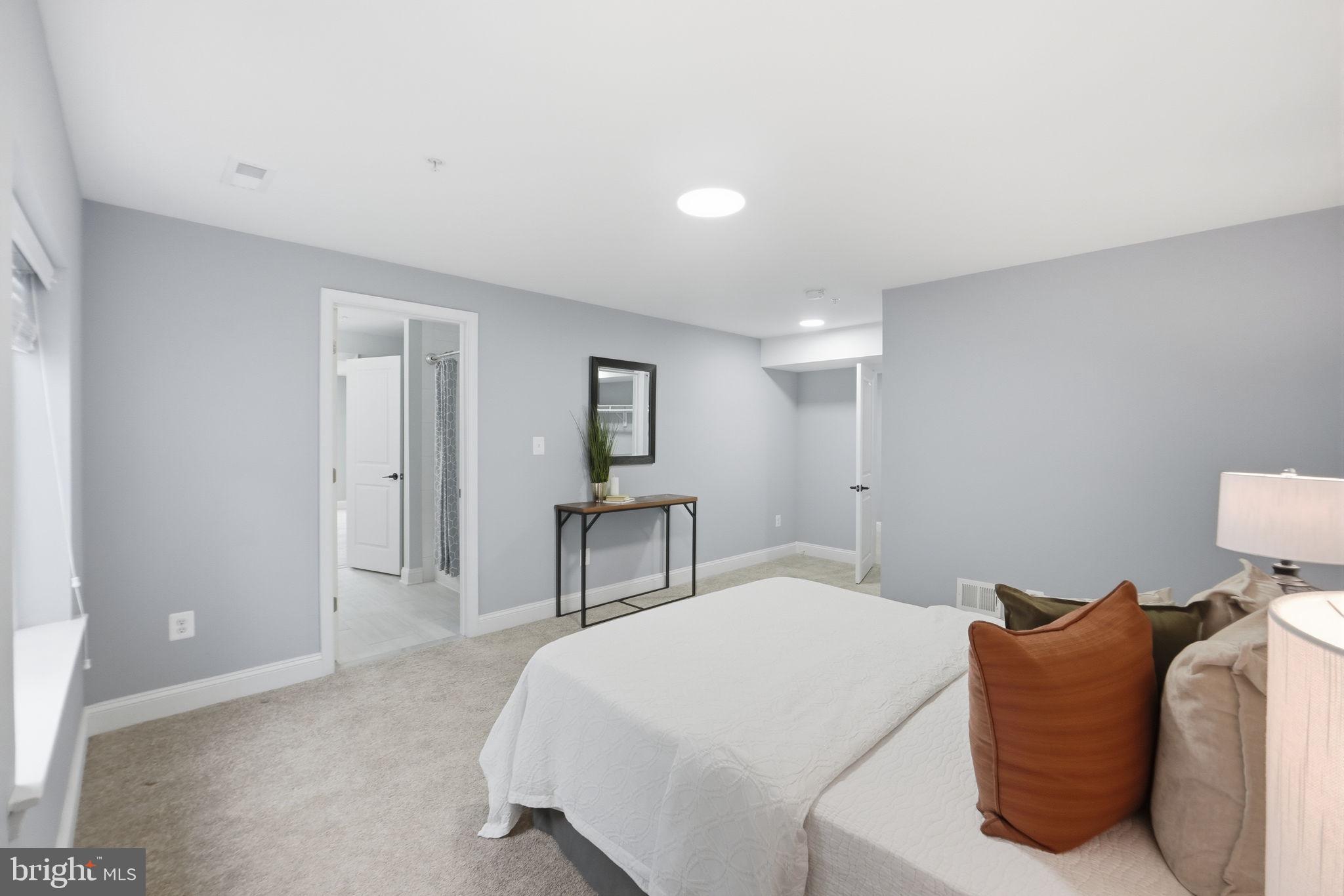 14309 Drayton Avenue Silver Spring, MD 20904 - Photo 35 of 44 a bedroom with a bed and a lamp with window