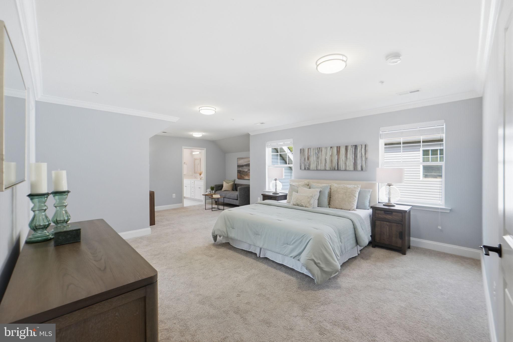 14309 Drayton Avenue Silver Spring, MD 20904 - Photo 4 of 44 a spacious bedroom with a bed a table and large window