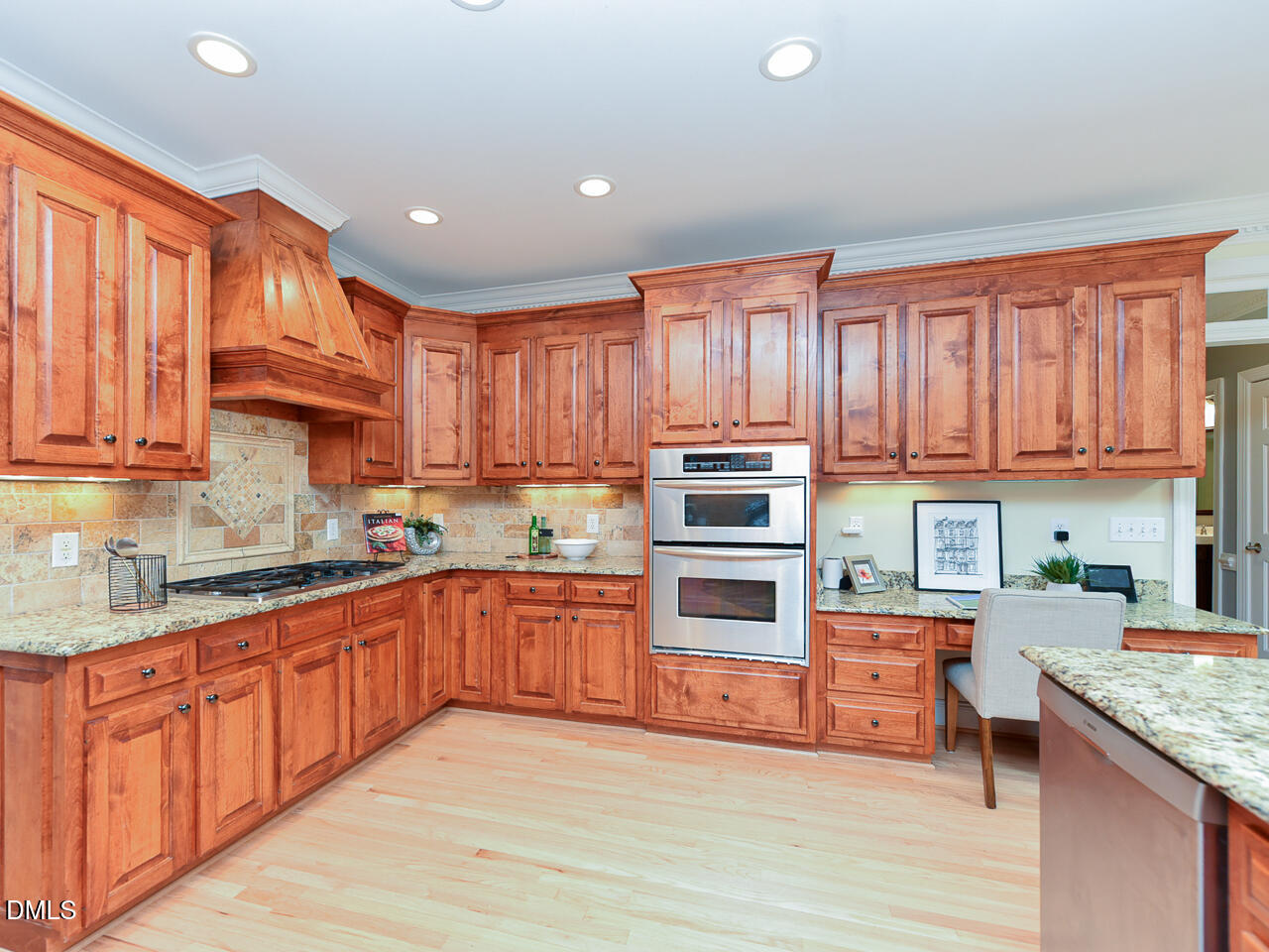 7108 Millstone Ridge Court Raleigh, NC 27614 - Photo 11 of 50 a kitchen with stainless steel appliances granite countertop a stove top oven a sink dishwasher and a refrigerator with wooden cabinets