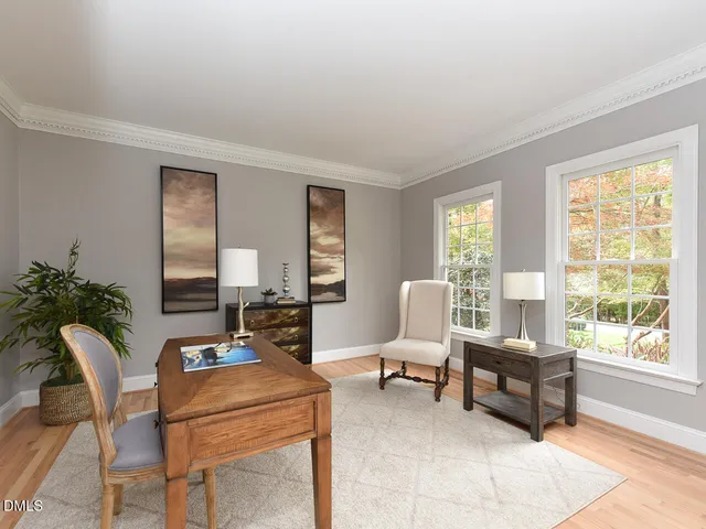 a living room with furniture and large windows
