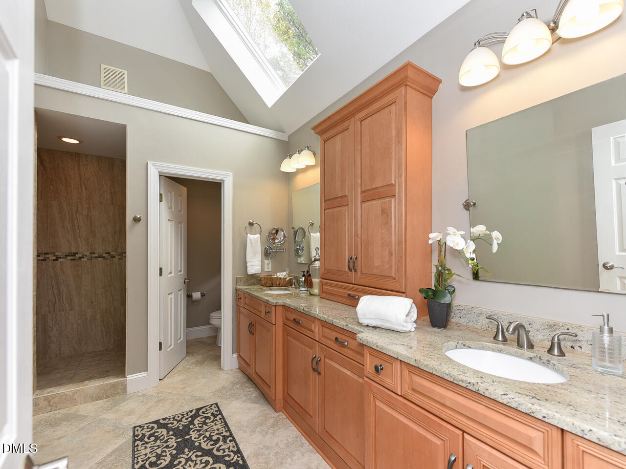 7108 Millstone Ridge Court Raleigh, NC 27614 - Photo 31 of 50 a spacious bathroom with a granite countertop sink mirror and a shower