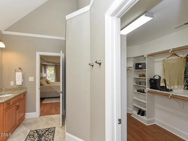 a view of walk in closet with clothes and shoes