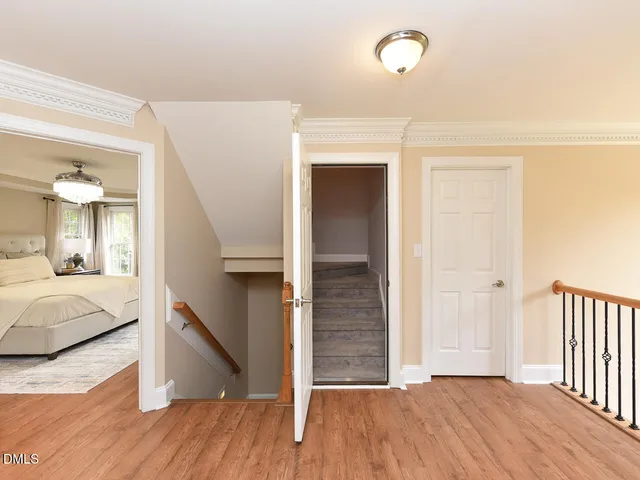 a view of hallway with wooden floor and a window