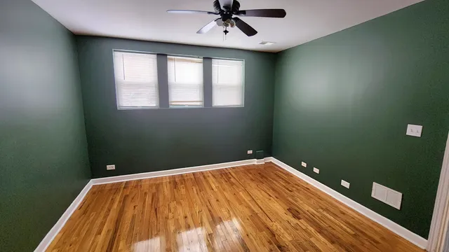 a view of a room with a ceiling fan
