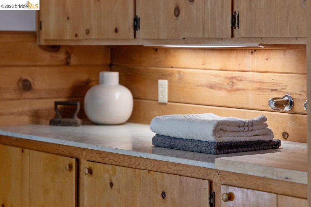 287 Purdue Avenue Kensington, CA 94708 - Photo 28 of 60 Custom knotty pine cabinetry featuring wood knobs and integrated under-cabinet lighting