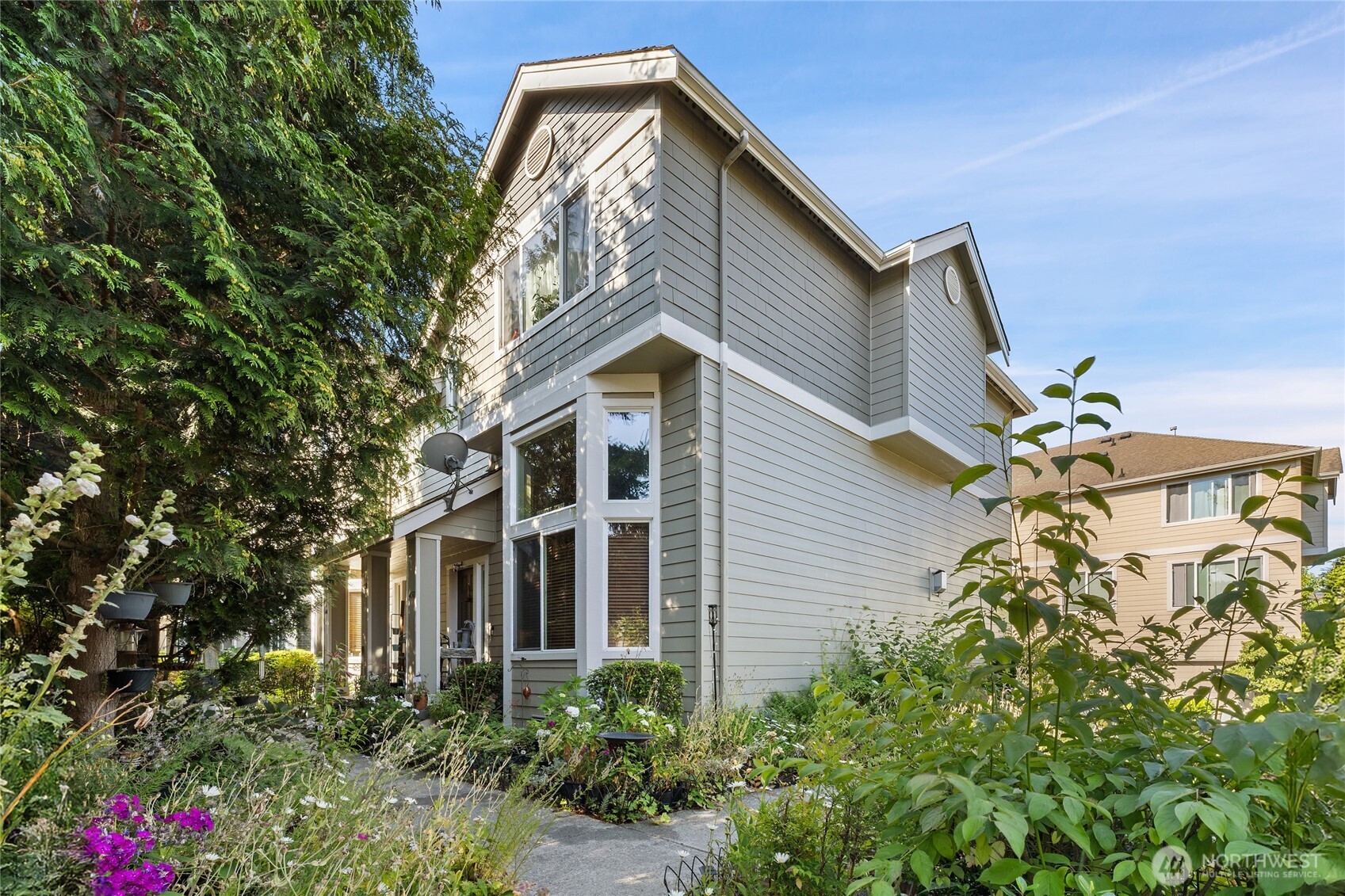 a front view of a house with a garden