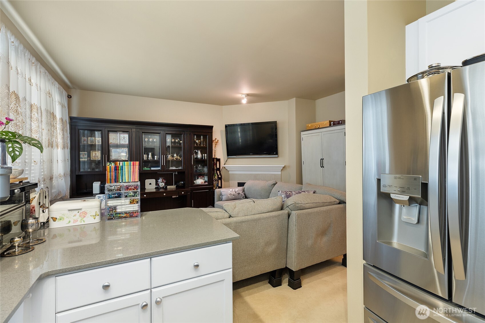 442 Tacoma Place Northeast Renton, WA 98056 - Photo 6 of 17 a living room with stainless steel appliances furniture a refrigerator and a sink