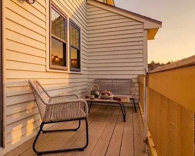 a balcony view with two chairs and a table