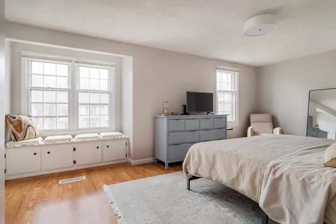 a spacious bedroom with a bed and a window
