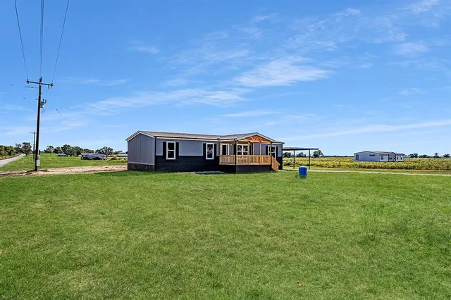 a view of a house with a big yard