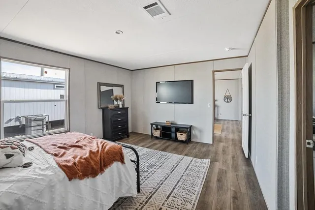 a bedroom with a bed and a flat screen television