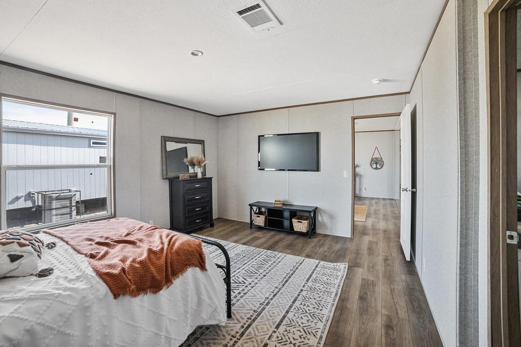 4127 Denver Road Sunset, TX 76270 - Photo 18 of 34 a bedroom with a bed and a flat screen television