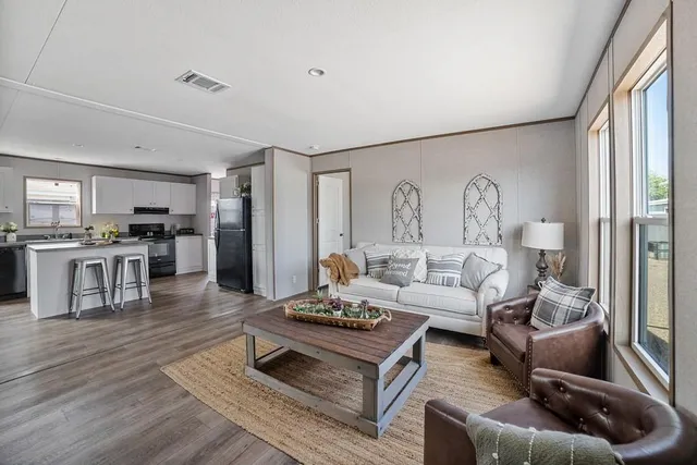 a living room with furniture and wooden floor