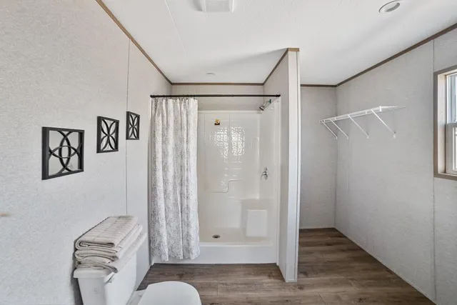 a bathroom with a shower and a mirror