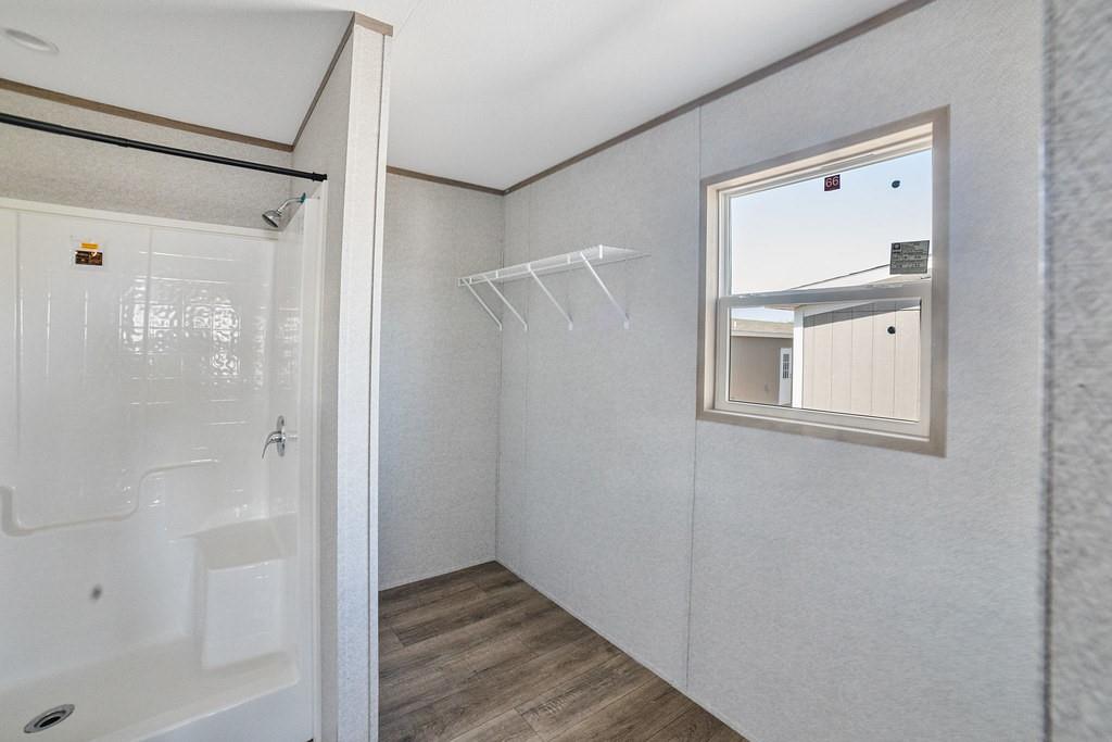 4127 Denver Road Sunset, TX 76270 - Photo 23 of 34 a bathroom with a shower and a mirror