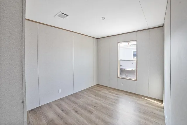 an empty room with windows and closet