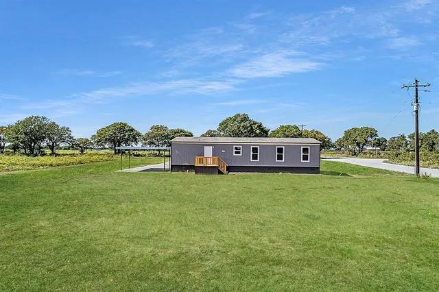 a view of a house with a big yard