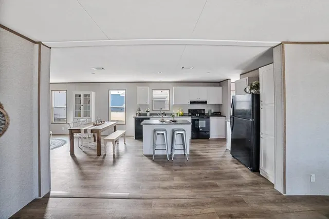 a kitchen with stainless steel appliances granite countertop a refrigerator and a stove top oven