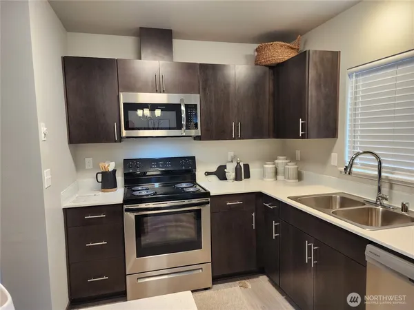 a kitchen with a sink and a stove top oven