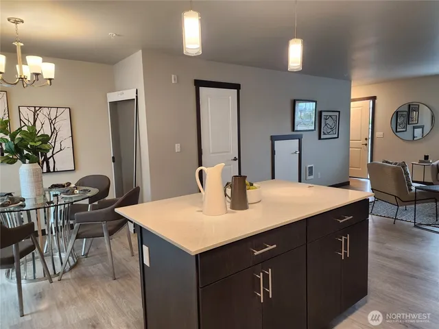 a room with a table chairs and entryway