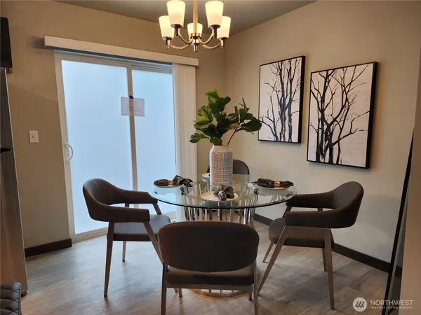 a dining room with furniture and chandelier