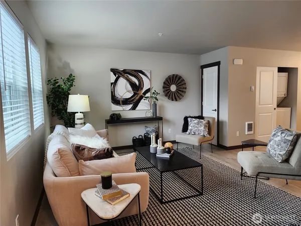 a living room with furniture and a rug