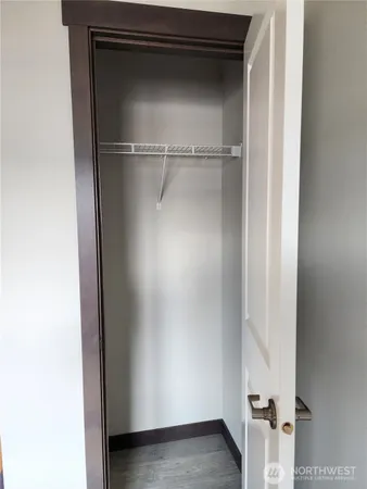 a view of walk in closet with empty racks