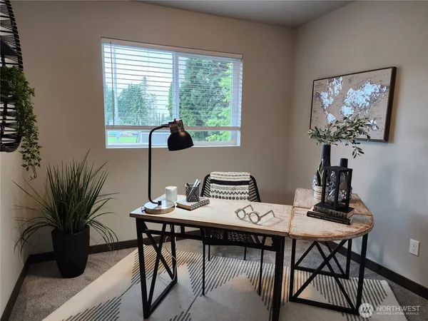 a view of a workspace with a table and chair in a room