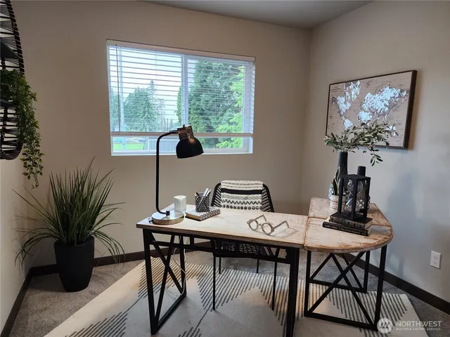 a view of a workspace with a table and chair in a room