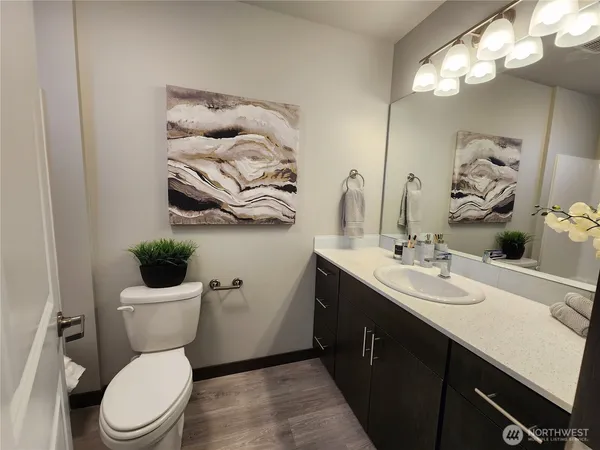 a bathroom with a toilet a sink and mirror