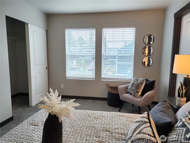 a bedroom with furniture and a window