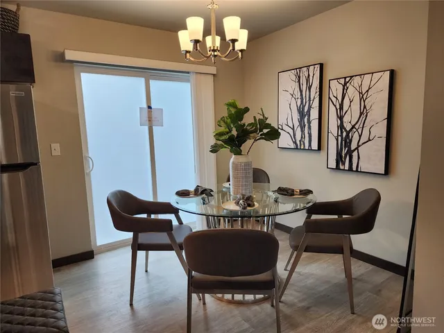 a view of a dining room with furniture and a chandelier