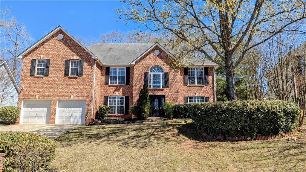 5928 Springfair Run Lithonia, GA 30038 - Photo 1 of 1 a front view of a house with a yard