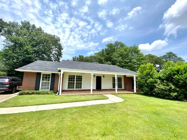 a front view of house with yard and green space