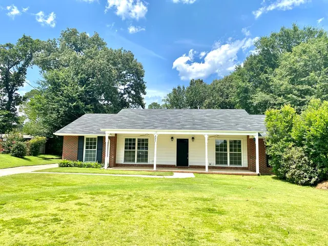 a view of a house with a backyard porch and sitting area