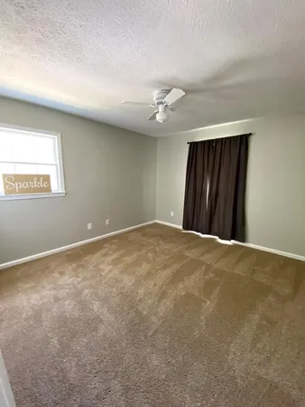 a view of an empty room and a window