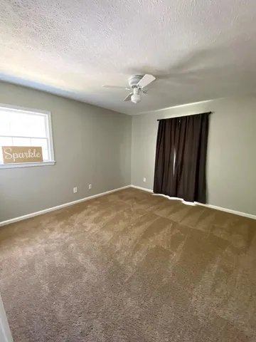 a view of an empty room and a window