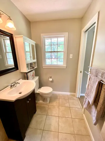a spacious bathroom with a double vanity sink a mirror and a
