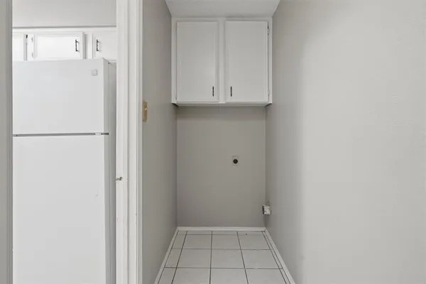 a view of a kitchen with white cabinets
