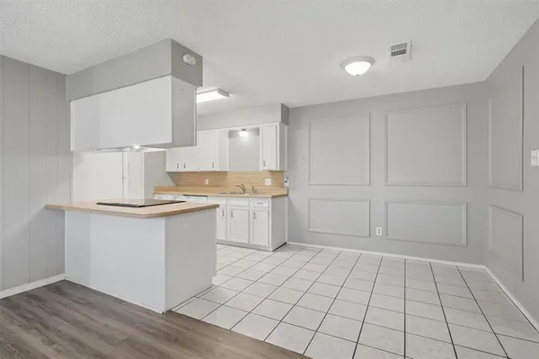 a kitchen with a sink cabinets and window