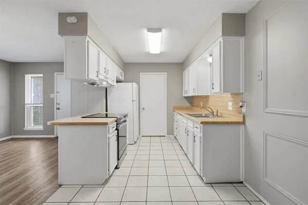 a kitchen with granite countertop a sink and a stove top oven