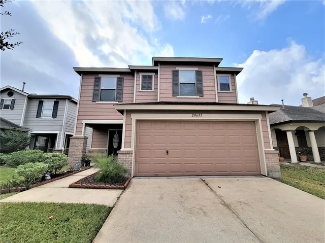 a front view of a house with a garage