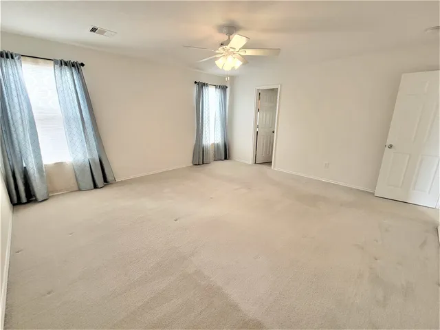 a view of a big room with windows and brick walls