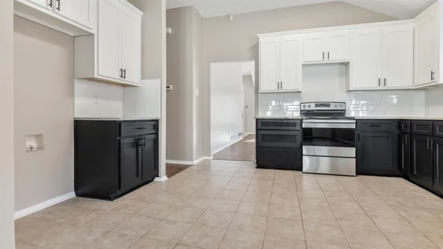 a kitchen with stainless steel appliances granite countertop a stove and a refrigerator