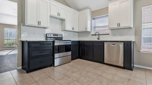 a kitchen with stainless steel appliances granite countertop a stove and a sink