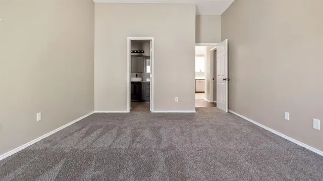 a view of an empty room with a cabinet and a window